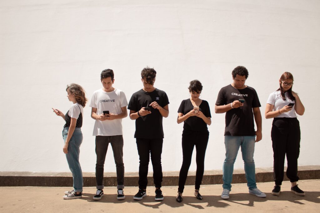 Image shows a line of young people using smartphones to view your enterprise website