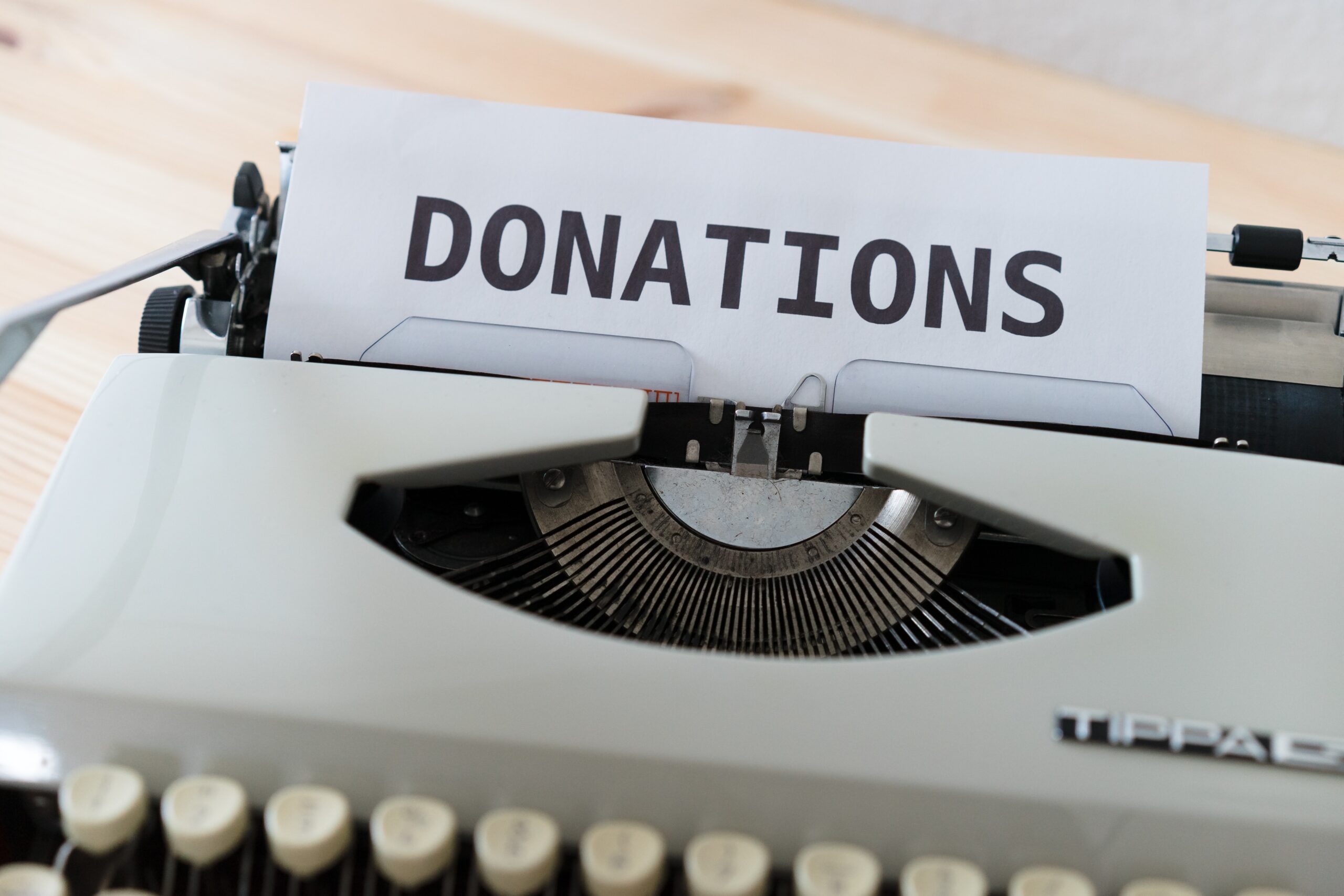 image showing a typewriter loaded with paper where the heading DONATIONS has been written to support fundraising automation content.